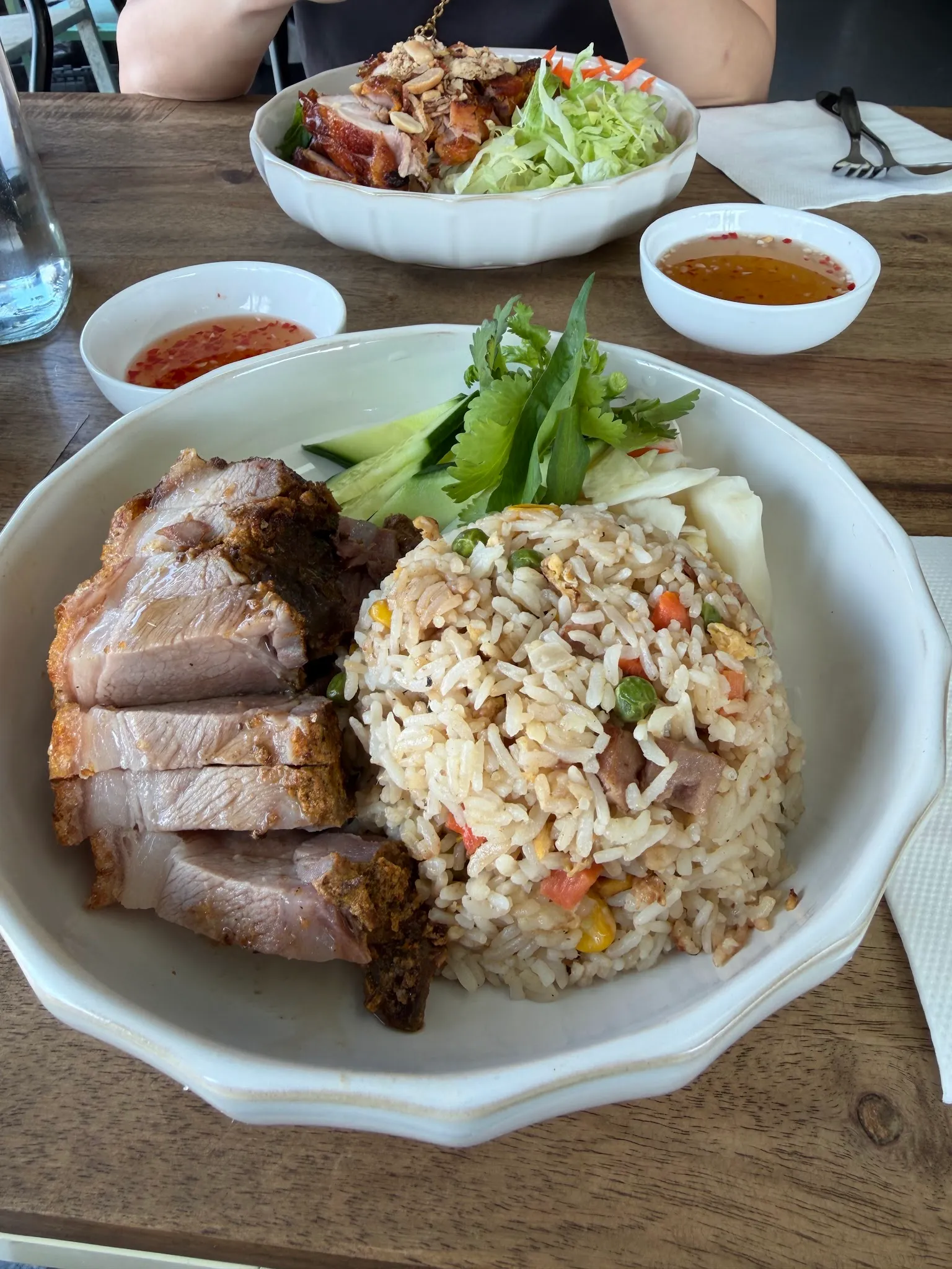 Plate of crispy roast pork with crackling and Vietnamese fried rice with dipping sauce